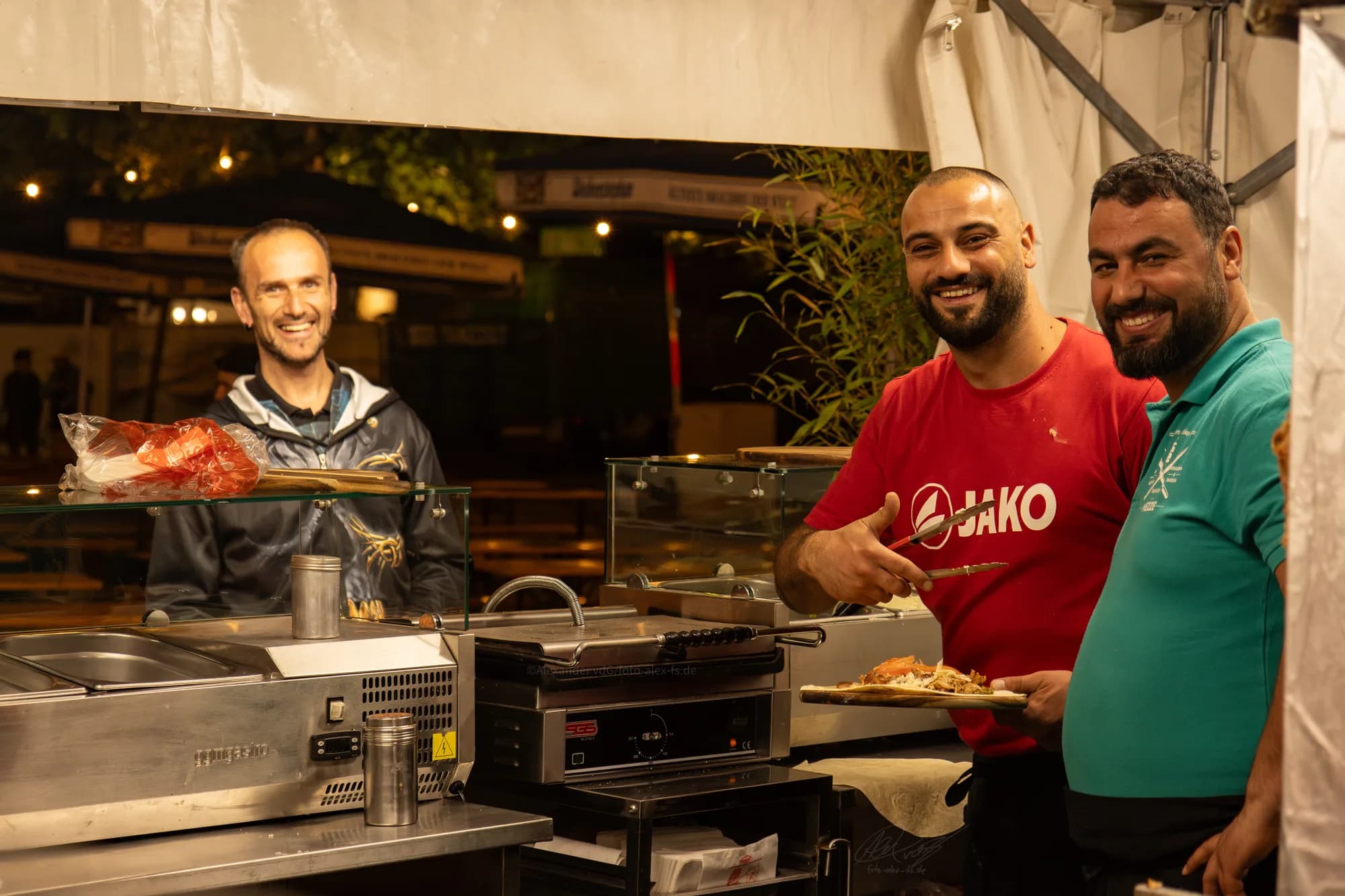 A crepe vendor hands a freshly made crepe to a customer at the festival.