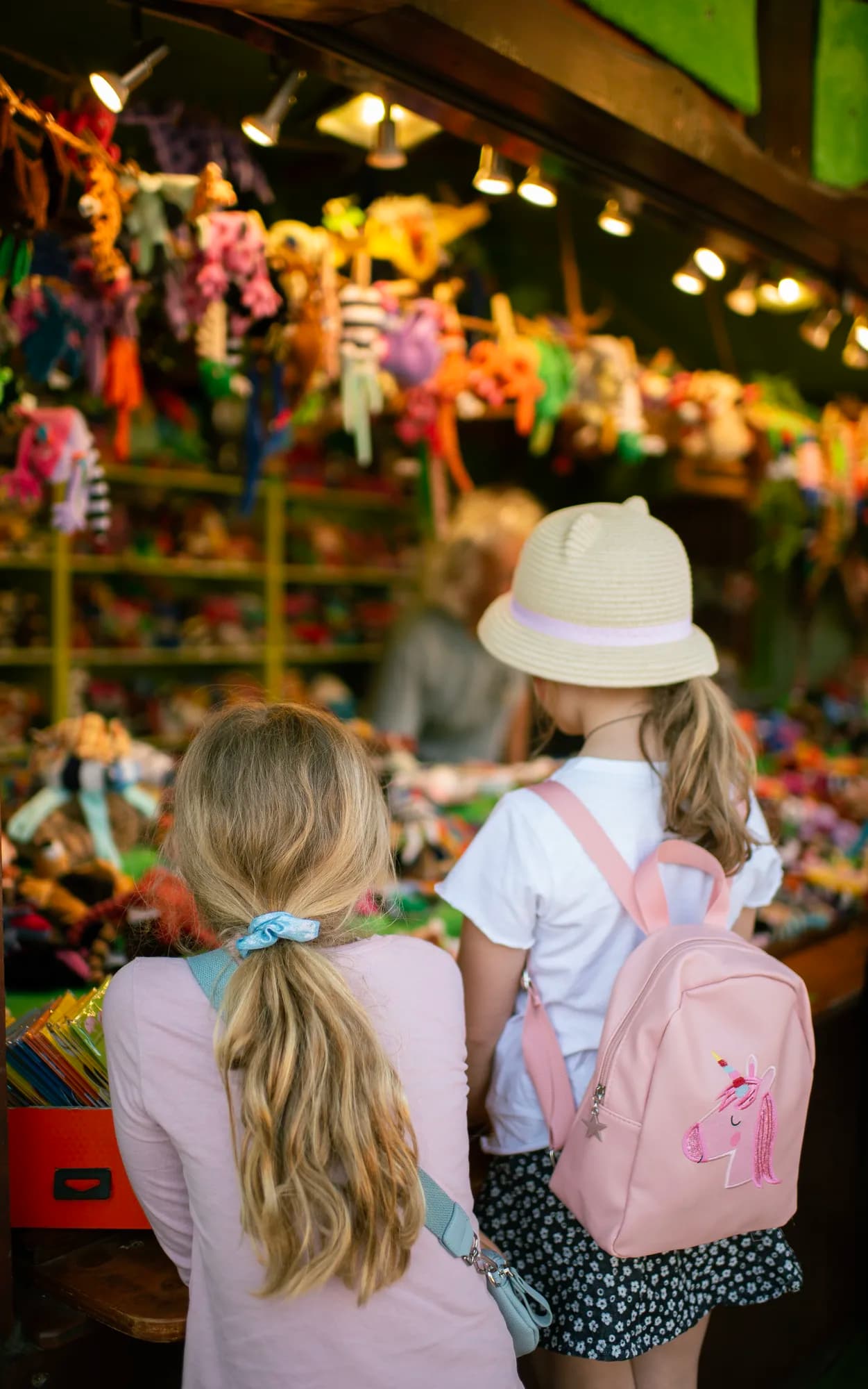 A bustling view of the festival market with vendors and visitors browsing stalls.