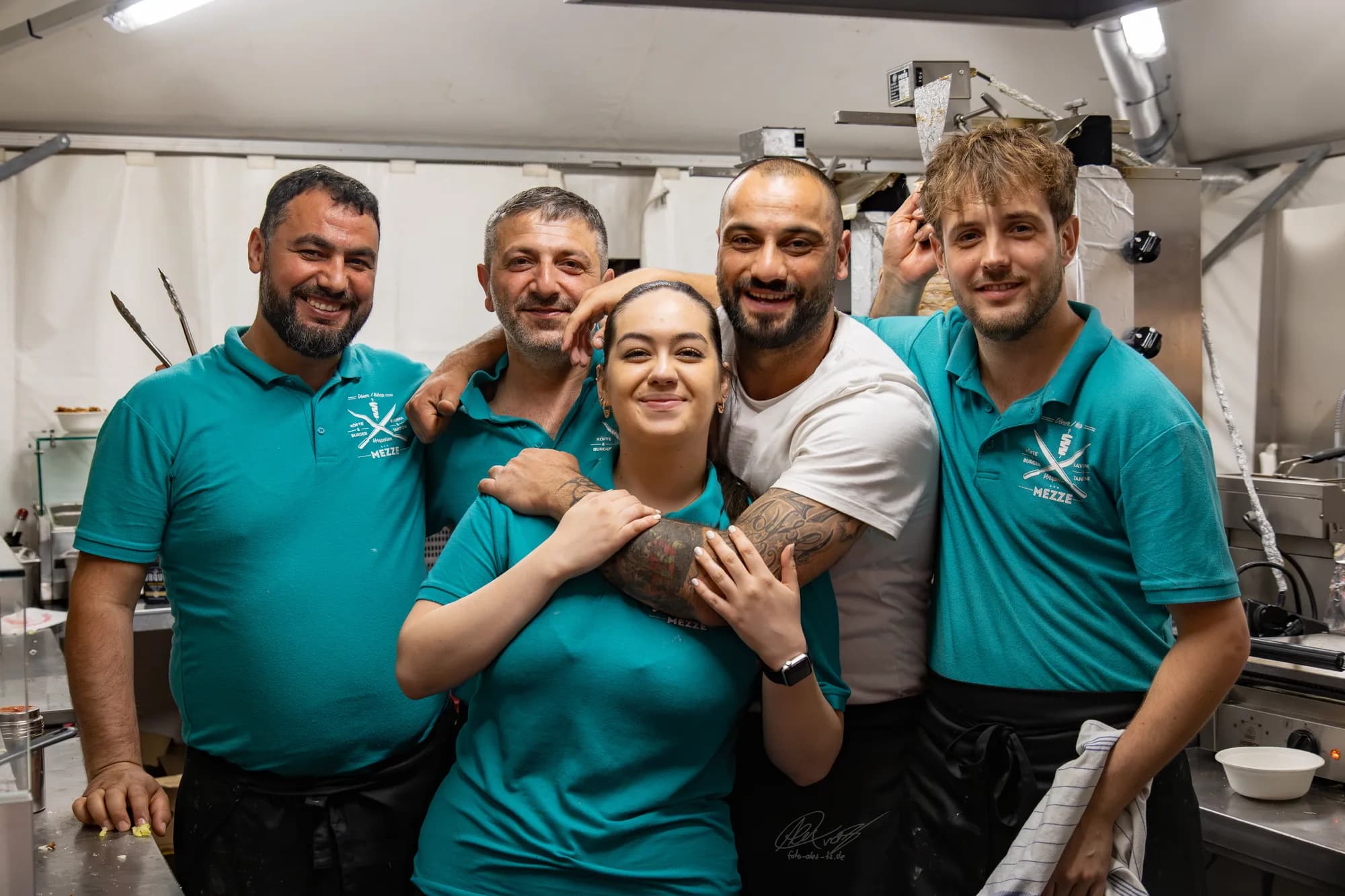 The festival food crew poses together for a group photo at their stand.